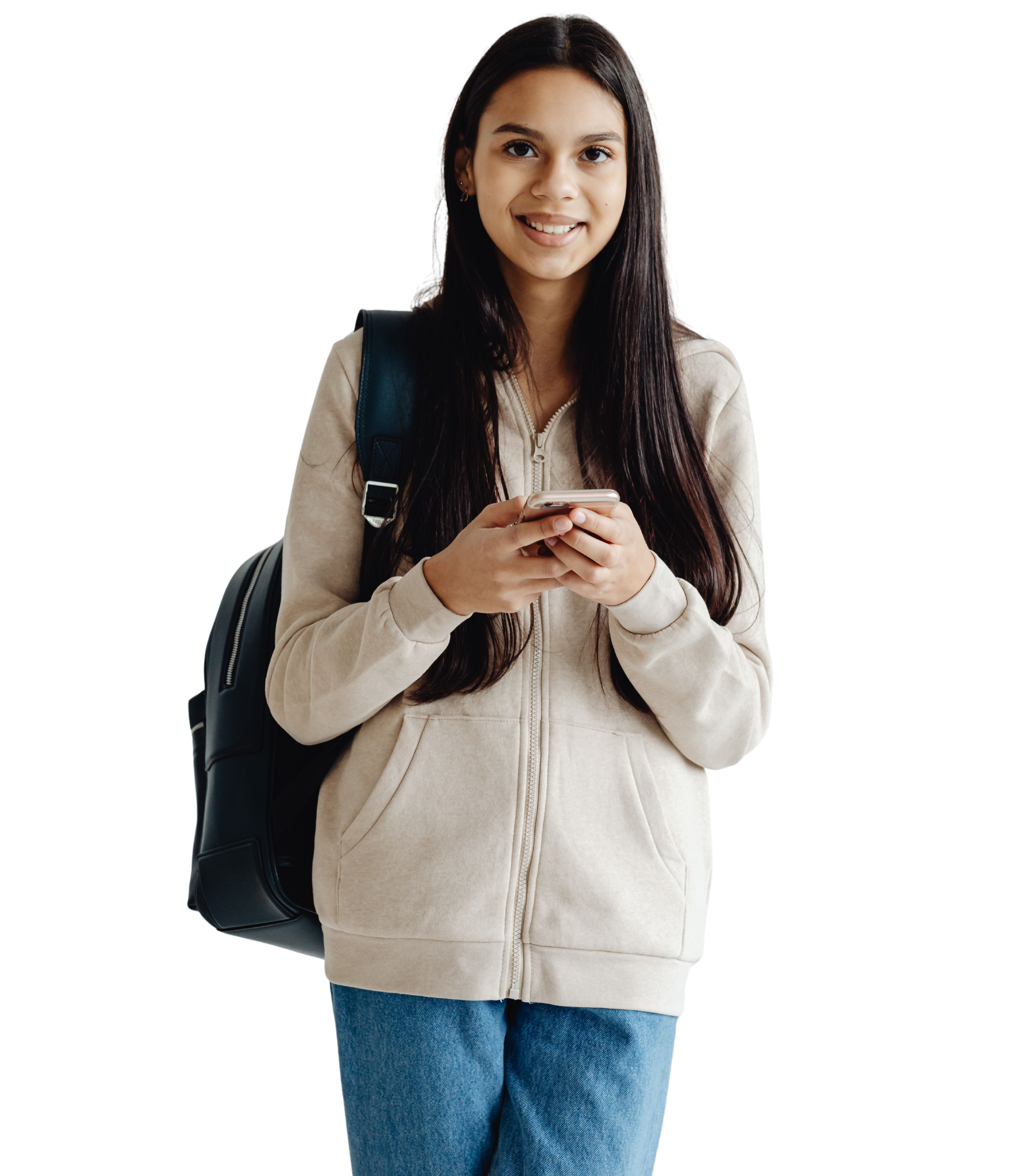 A young person with a backpack smiling and holding their phone